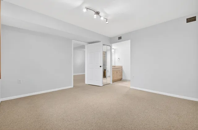 a view of an empty room with a ceiling fan