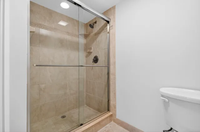 a bathroom with a shower and a toilet