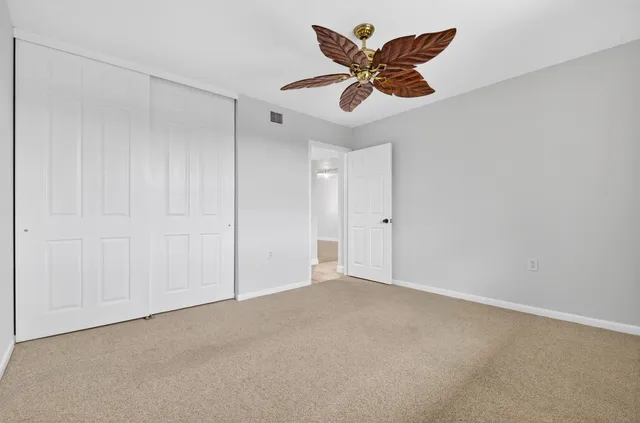 an empty room with a ceiling fan and a ceiling fan