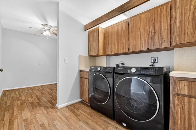 a utility room with sink dryer and washer