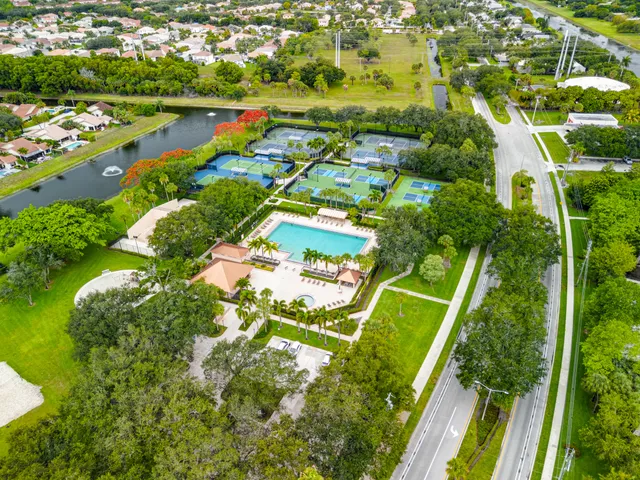 an aerial view of residential houses with outdoor space and street view