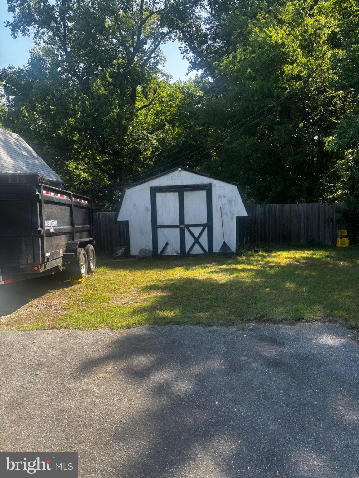 4304 Largo Road Upper Marlboro, MD 20772 - Photo 5 of 5 Charming shed nestled in lush greenery.
