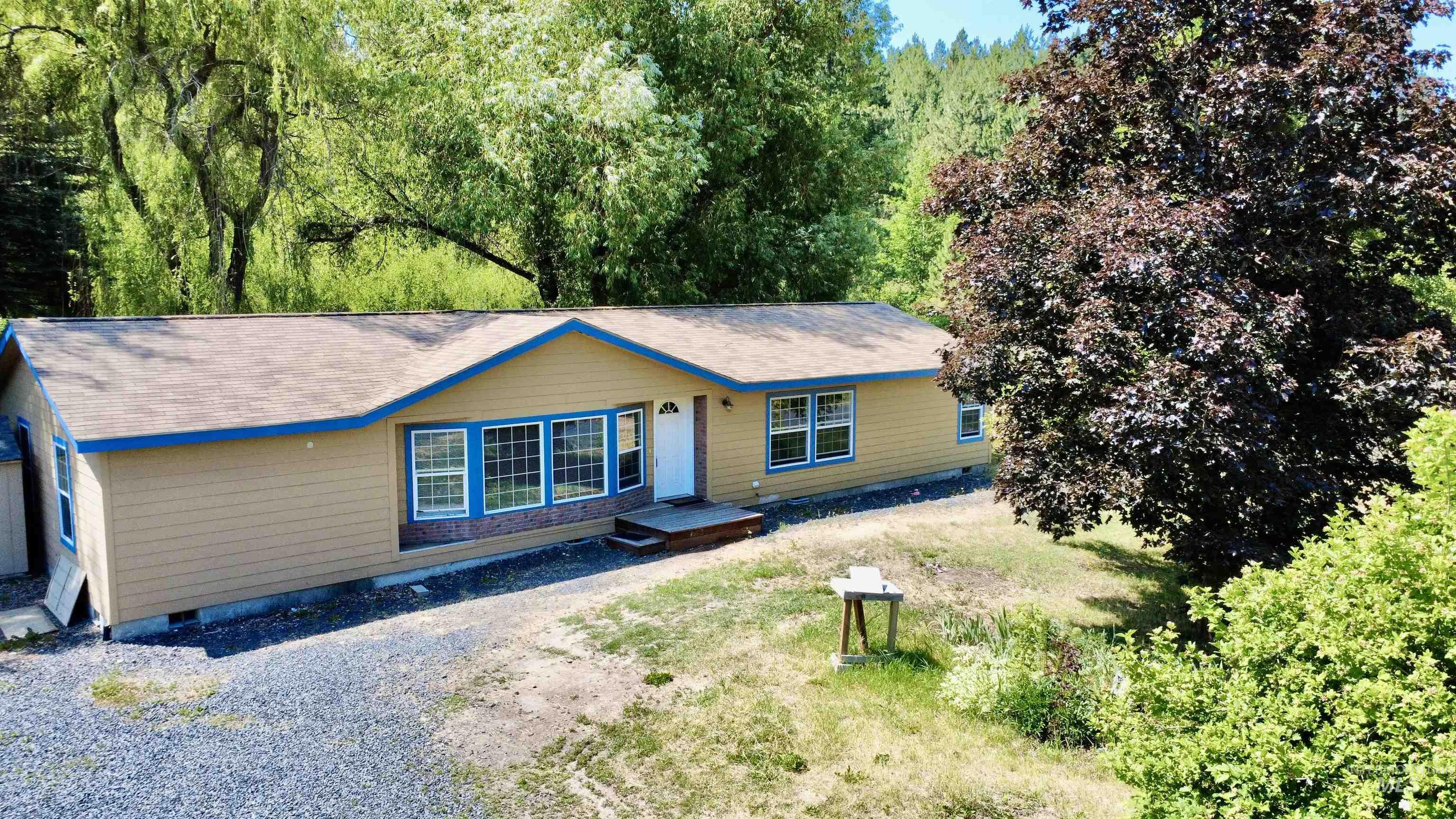 1089 Wallen Road Moscow, ID 83843 - Photo 3 of 43 View of front facade featuring crawl space, gravel driveway, and a view of trees