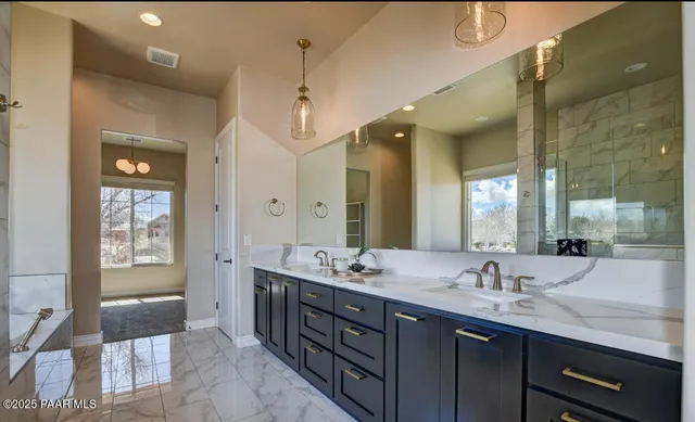 a bathroom with a granite countertop sink and a toilet