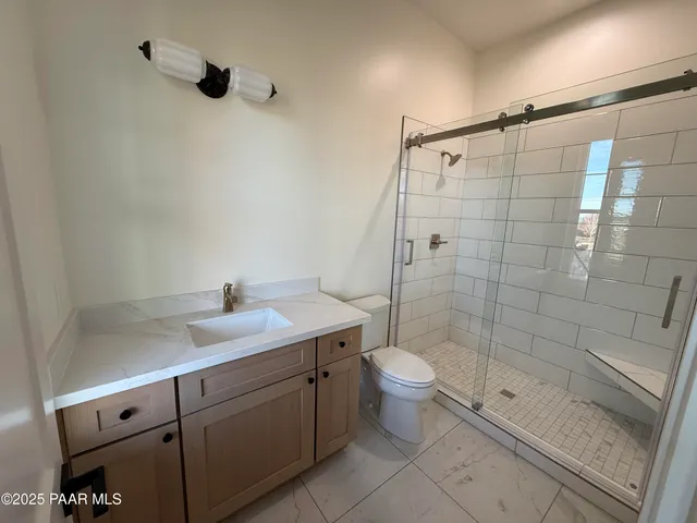 a kitchen with white cabinets and a sink