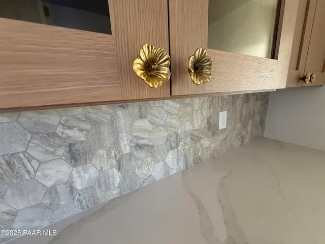 a view of a kitchen with wooden floor and electronic appliances