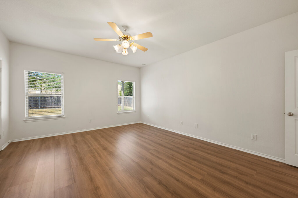 11744 Easy Street Austin, TX 78748 - Photo 28 of 40 Rich wood-inspired flooring pairs with neutral walls in this versatile living space.