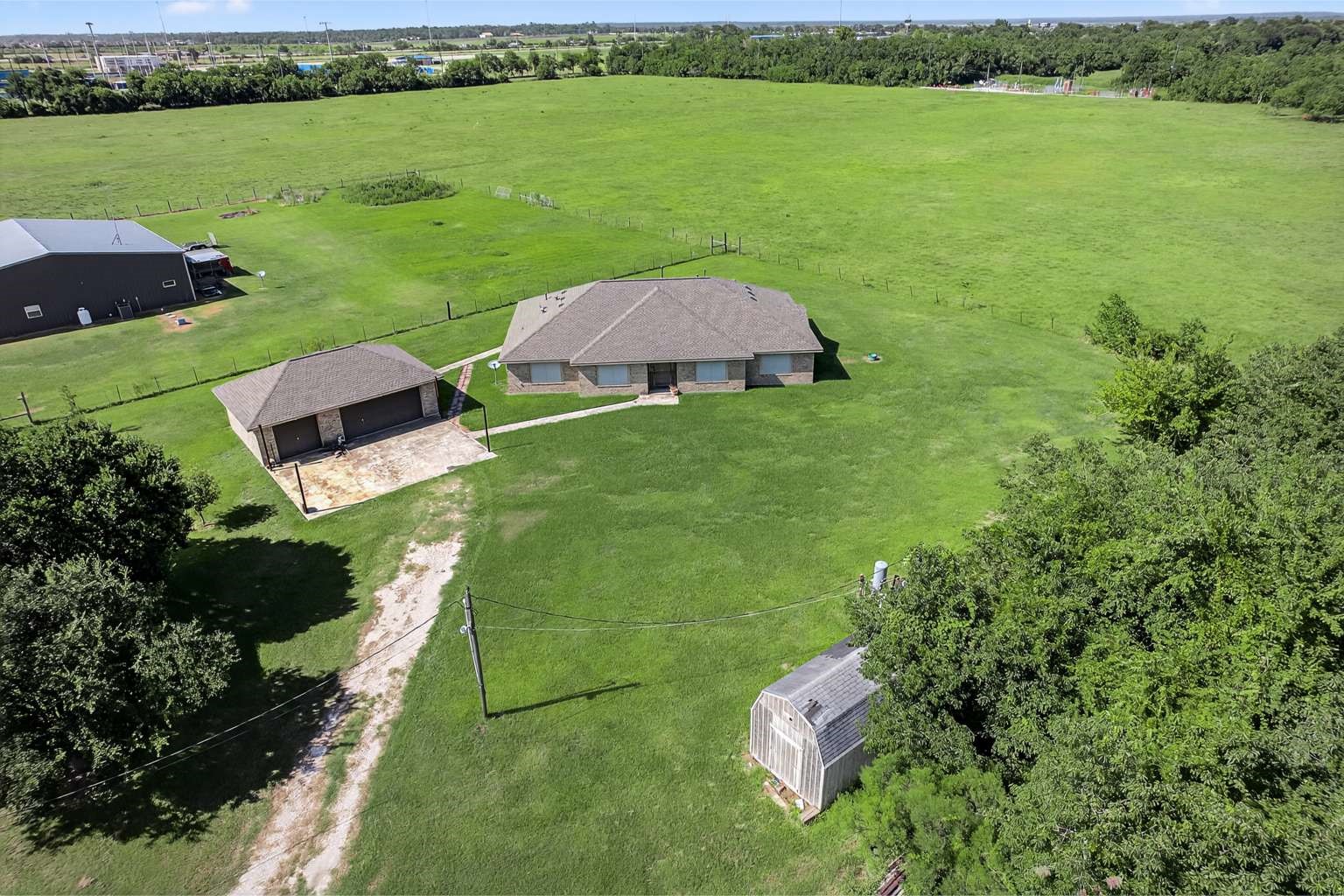 329 Gou Hole Road Cove, TX 77523 - Photo 1 of 19 a view of a lake with a yard and large trees