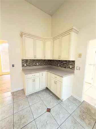 a kitchen with stainless steel appliances granite countertop a stove a sink and white cabinets