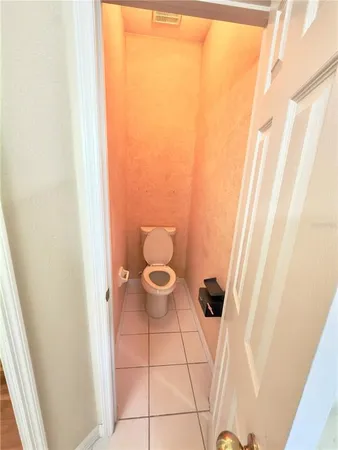 a bathroom with a toilet and a window
