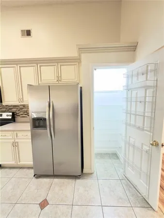 a metallic refrigerator freezer sitting in a kitchen