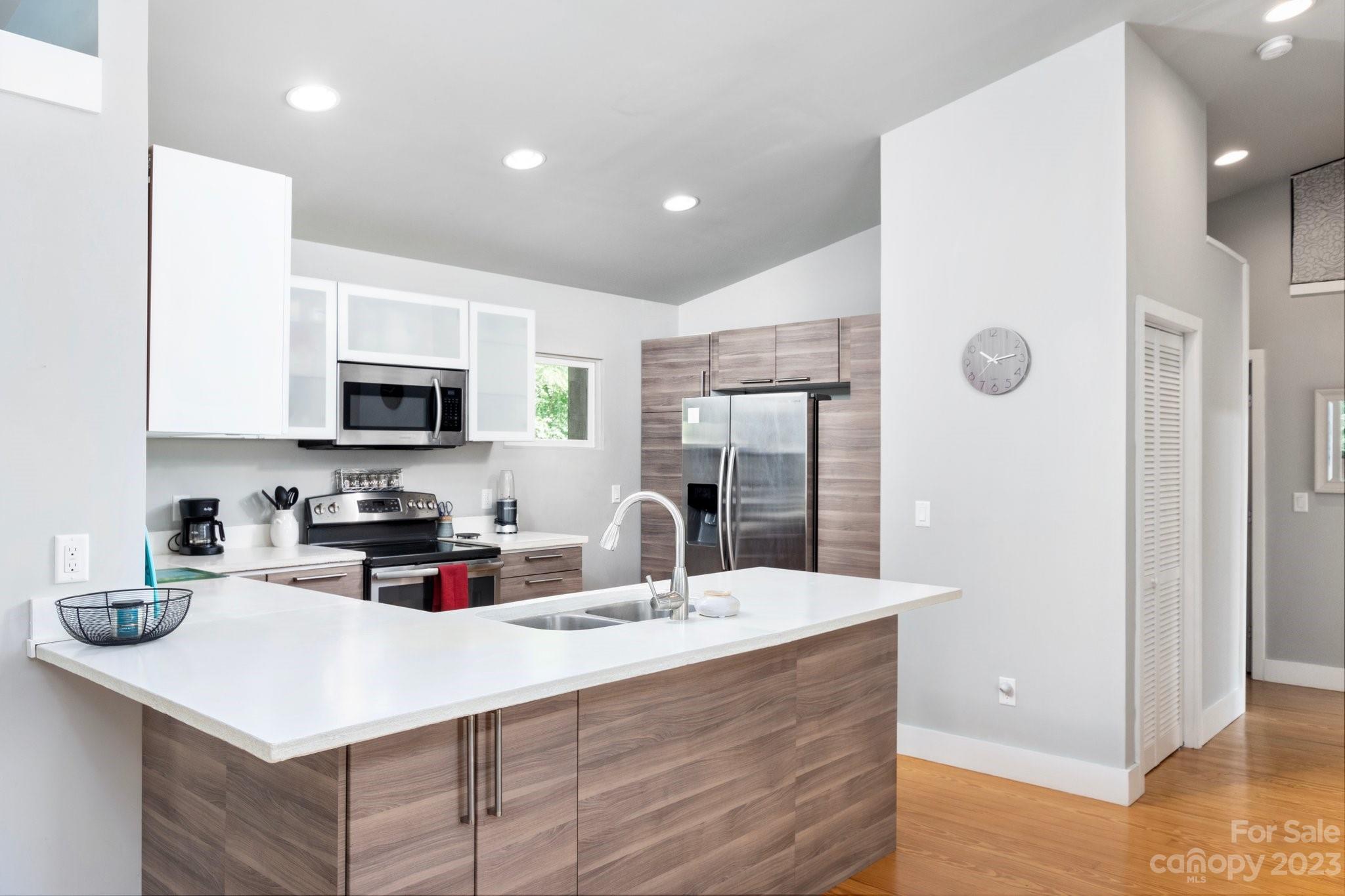 43 Kirkman Road Asheville, NC 28805 - Photo 11 of 27 a kitchen with stainless steel appliances a sink a stove a refrigerator and cabinets
