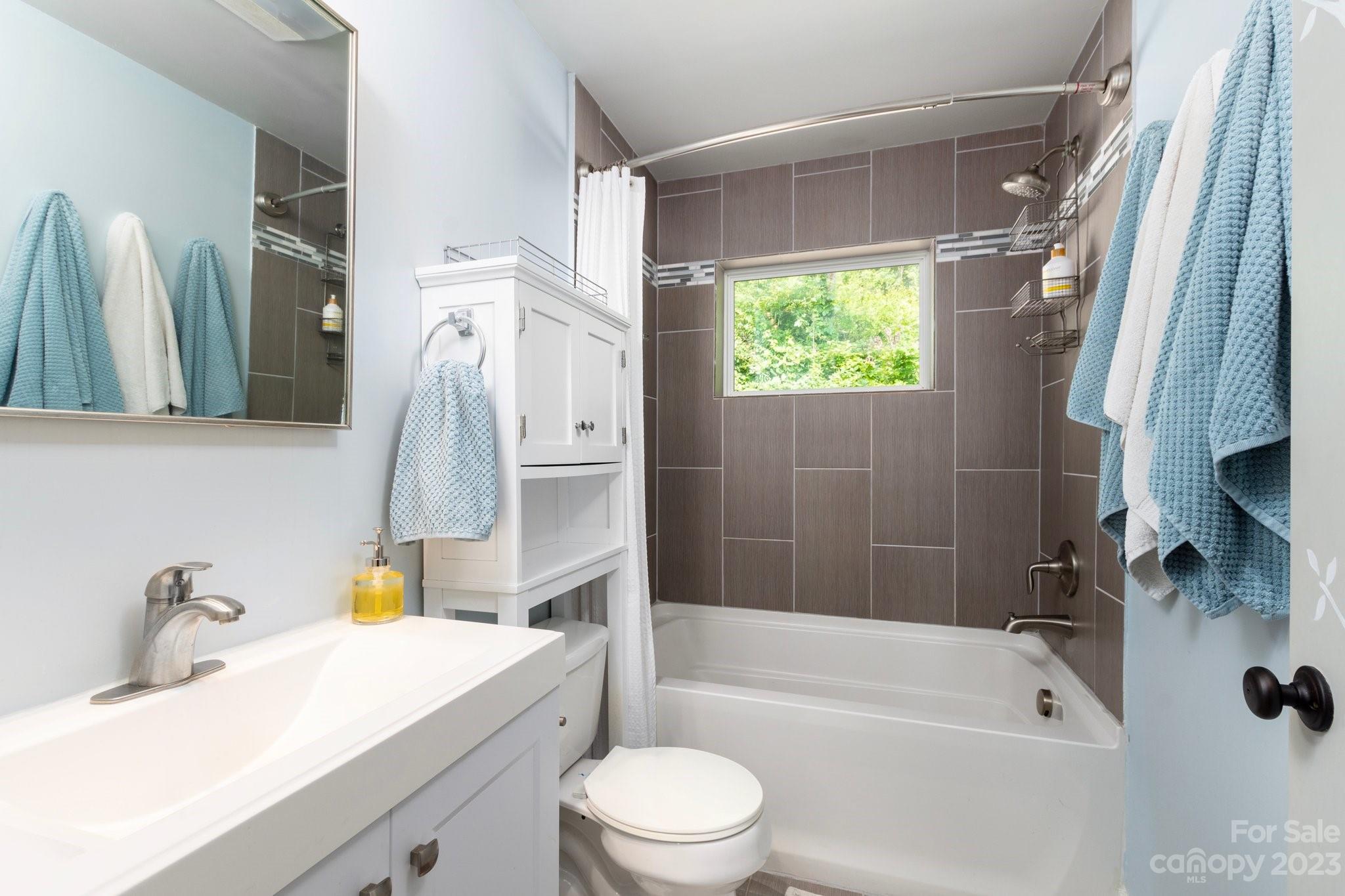 43 Kirkman Road Asheville, NC 28805 - Photo 16 of 27 a bathroom with a sink toilet and shower