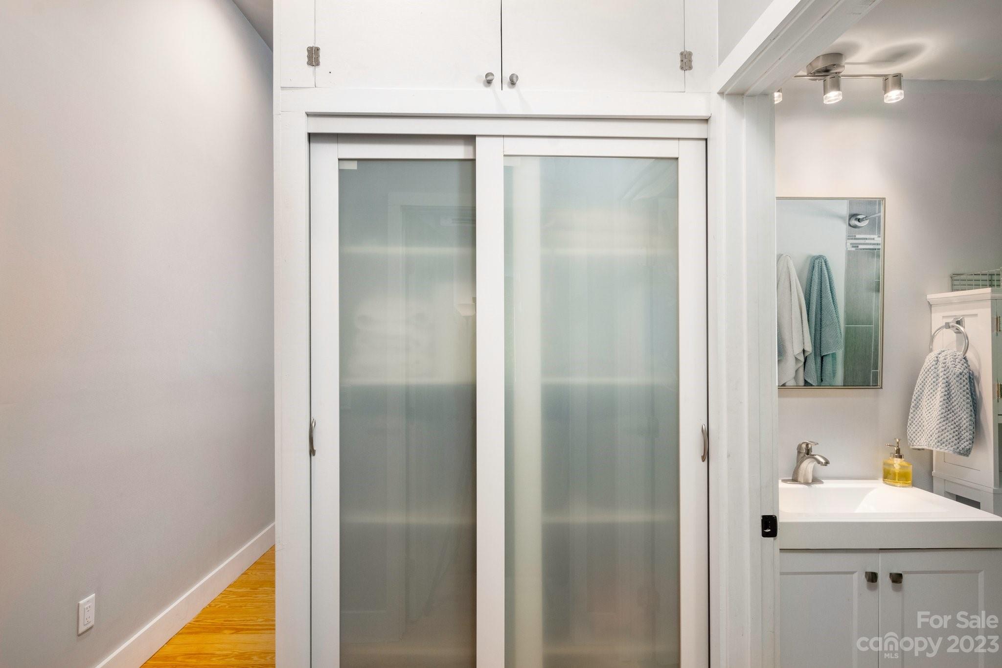 43 Kirkman Road Asheville, NC 28805 - Photo 23 of 27 a bathroom with a sink mirror and a shower