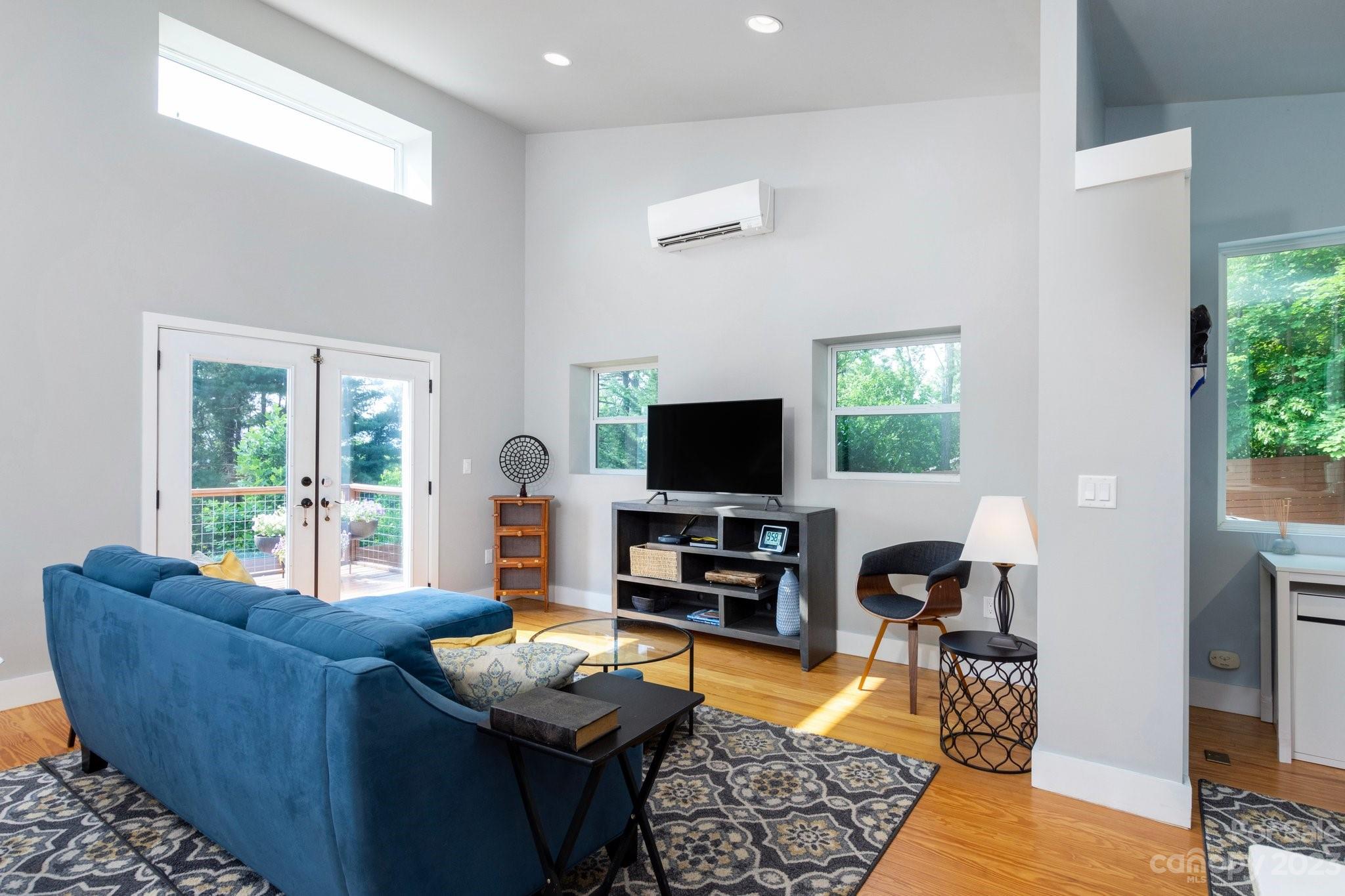 43 Kirkman Road Asheville, NC 28805 - Photo 5 of 27 a living room with furniture a flat screen tv and a large window