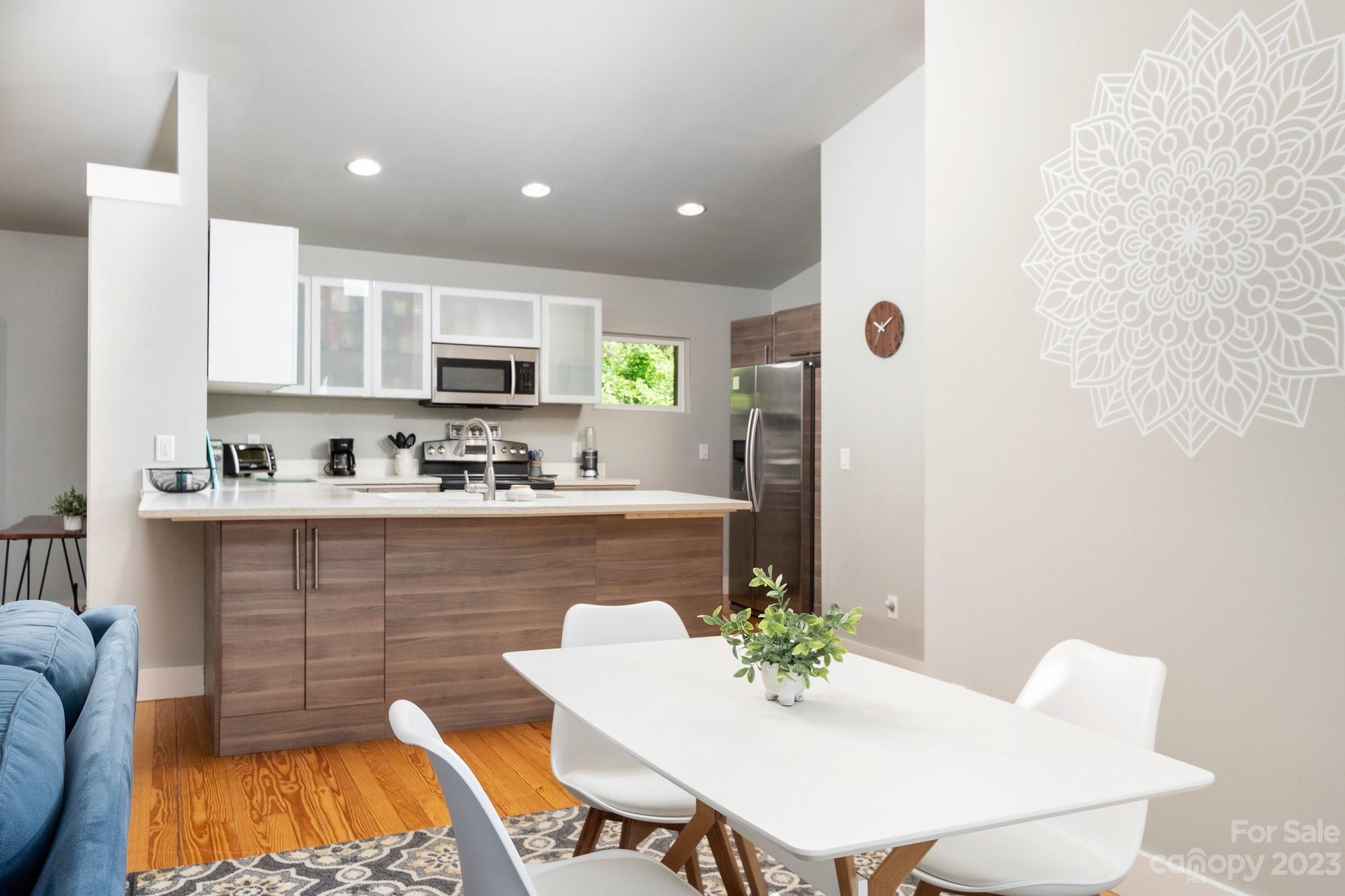 43 Kirkman Road Asheville, NC 28805 - Photo 9 of 27 a kitchen with stainless steel appliances kitchen island granite countertop a sink and a refrigerator