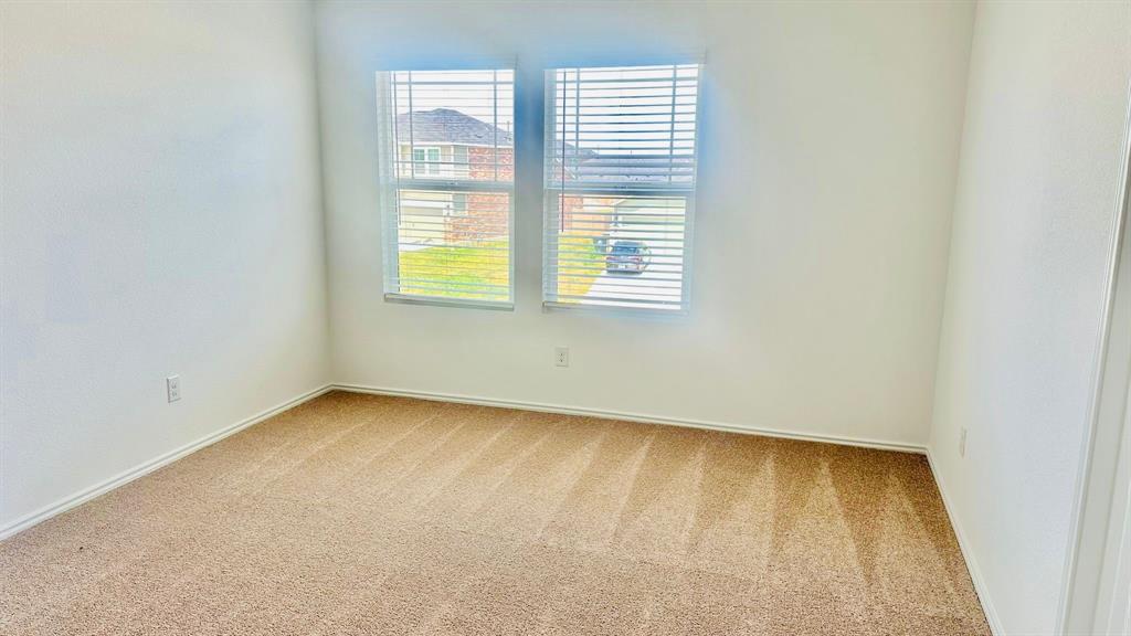 192 Rodney Boat Road Kyle, TX 78640 - Photo 32 of 38 Sun-filled room featuring plush carpeting and natural light from dual windows.