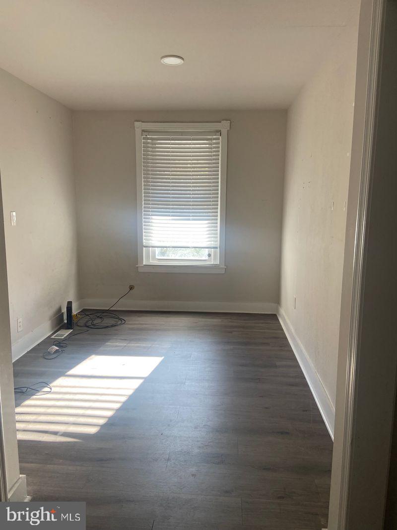 67 East Collom Street Philadelphia, PA 19144 - Photo 6 of 6 an empty room with wooden floor and windows