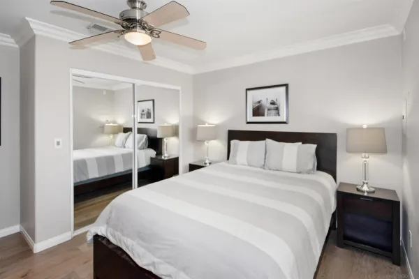 a bedroom with a bed and a chandelier