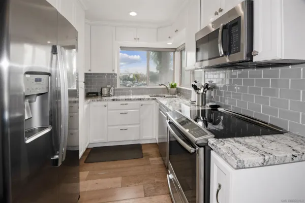a kitchen with a sink stove and refrigerator