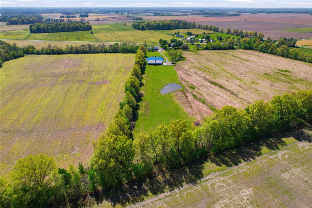1602 Westboro Road Blanchester, OH 45107 - Photo 58 of 81 This sweeping aerial view captures a serene landscape with lush greenery and tranquil waters.