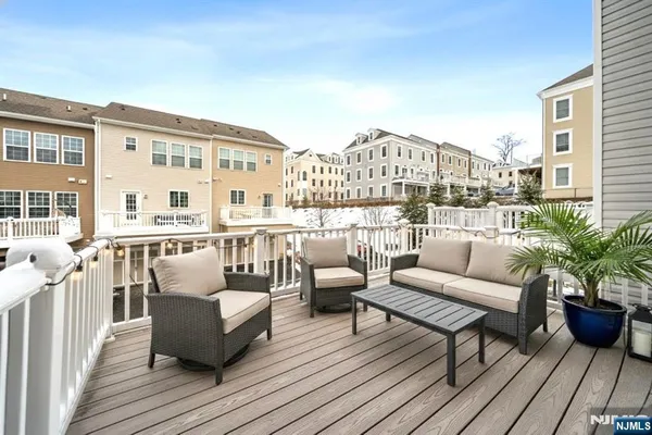 a balcony with wooden floor and couches