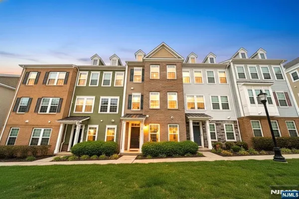 a front view of a residential apartment building with a yard