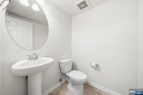 a bathroom with a sink toilet and a mirror
