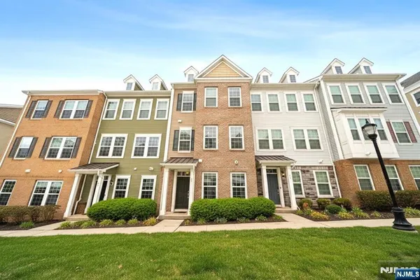 a front view of a residential apartment building with a yard