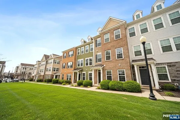 a front view of a building with a yard