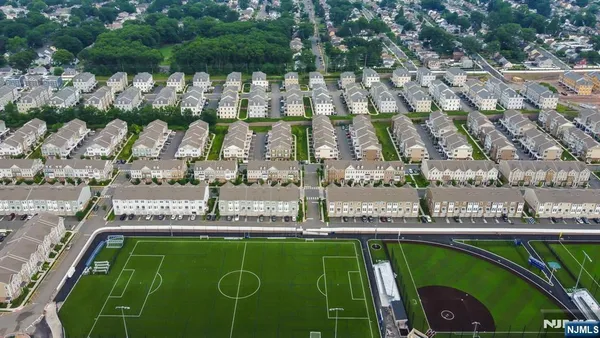 a view of swimming pool with a yard and plants