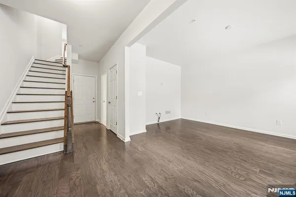 a view of a room with wooden floor