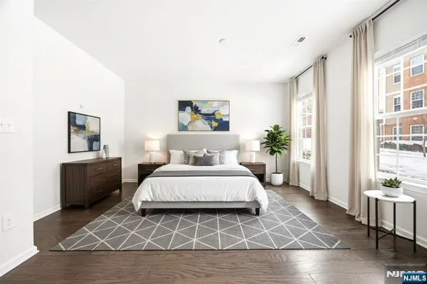a spacious bedroom with a bed and a table
