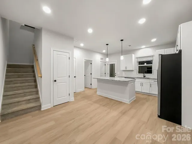 a large kitchen with a lot of counter space and a refrigerator