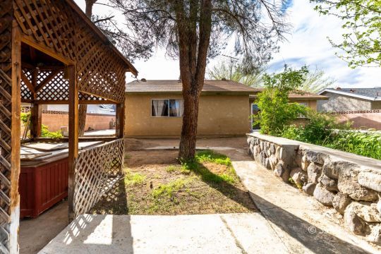 1224 North Inyo Street Ridgecrest, CA 93555 - Photo 27 of 28 a view of a house with a large tree in front of it