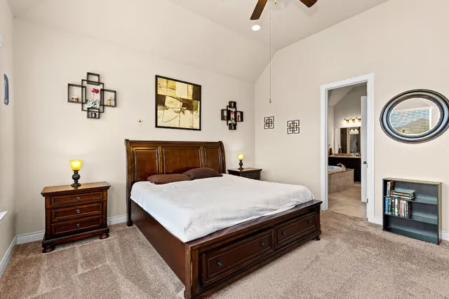 a spacious bedroom with a bed and a chandelier