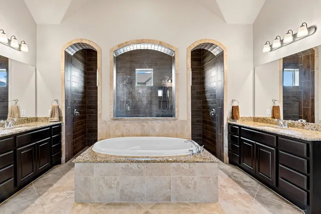 a spacious bathroom with a granite countertop sink and a mirror