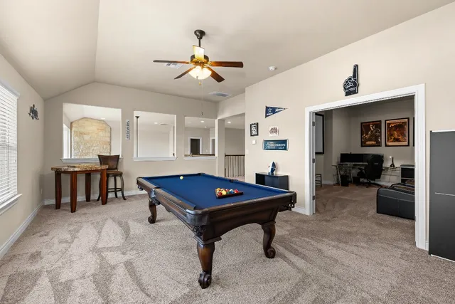 a room with furniture and pool table