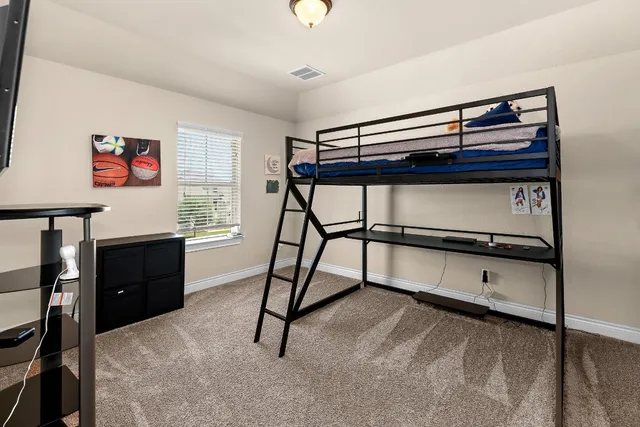 a bedroom with furniture and a window