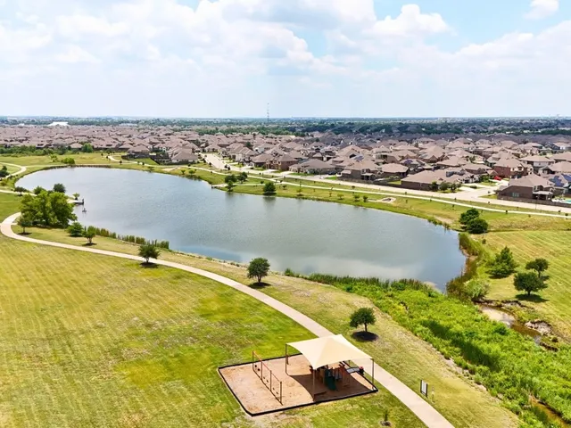 an aerial view of a swimming pool and lake view