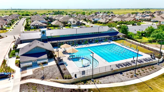 a view of a balcony with wooden floor and outdoor seating