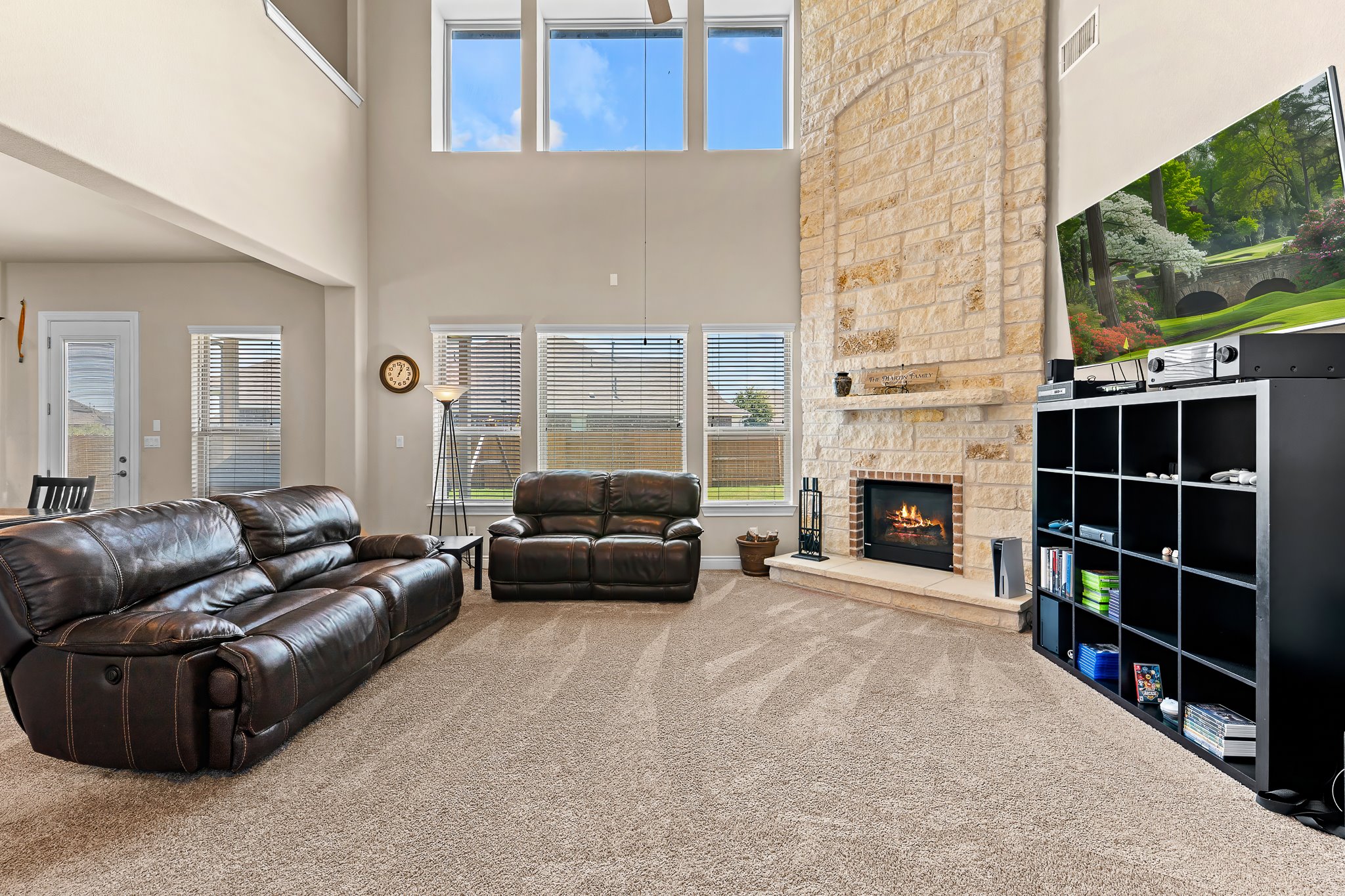 3501 Great Knot Pass Pflugerville, TX 78660 - Photo 5 of 40 a living room with furniture a fireplace and a flat screen tv