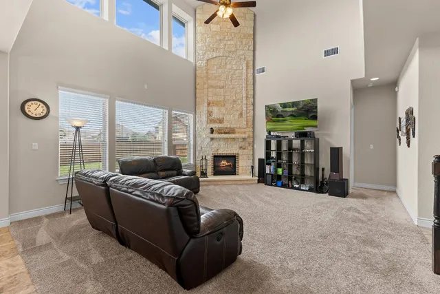 a living room with furniture fireplace and a floor to ceiling window