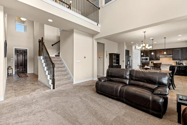 a view of a living room kitchen and a chandelier