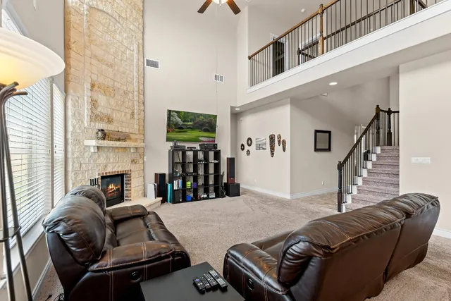 a living room with furniture fireplace and flat screen tv