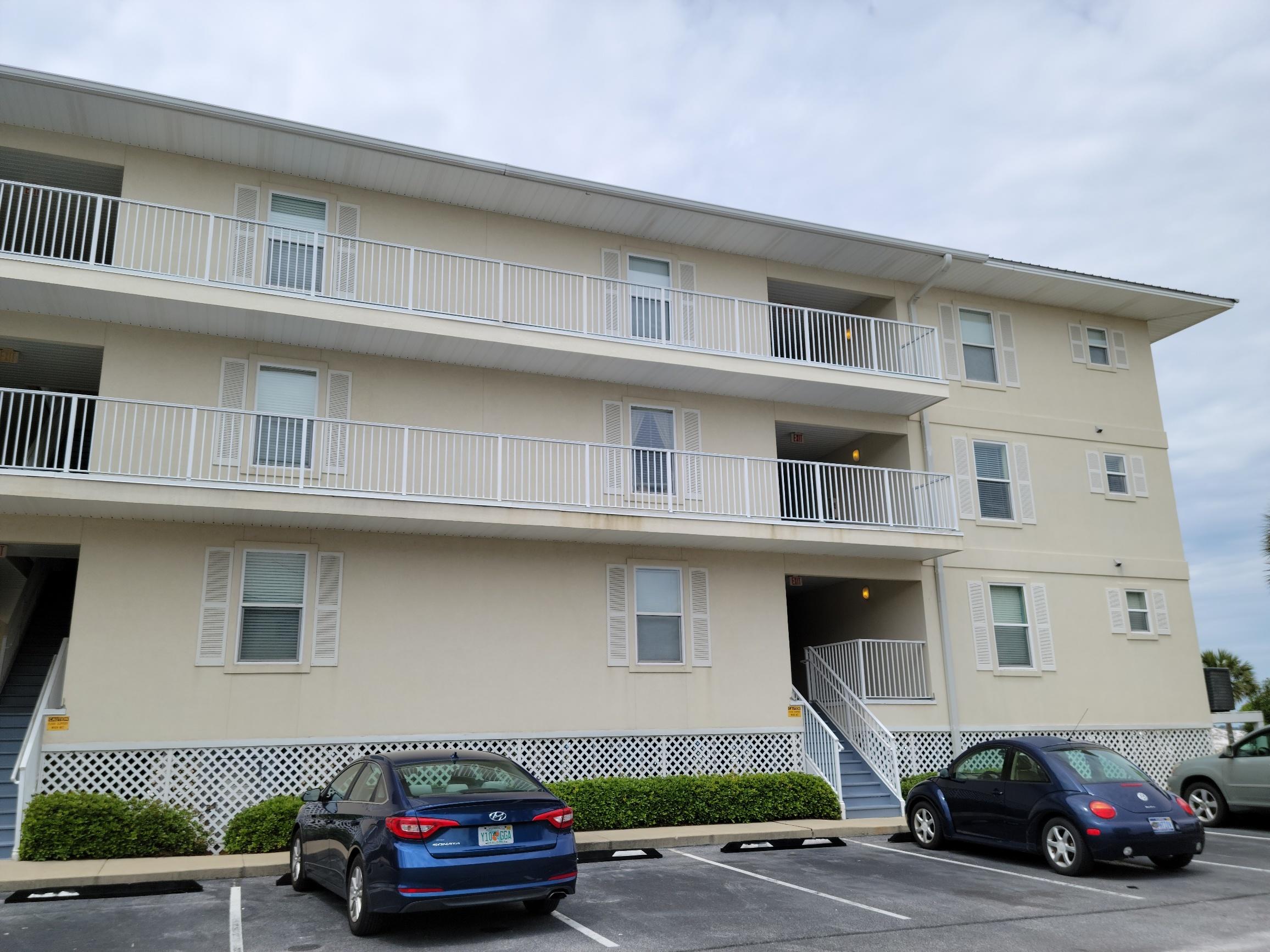 8436 Gulf Boulevard, Unit 423 Navarre, FL 32566 - Photo 4 of 7 a car parked in front of a building