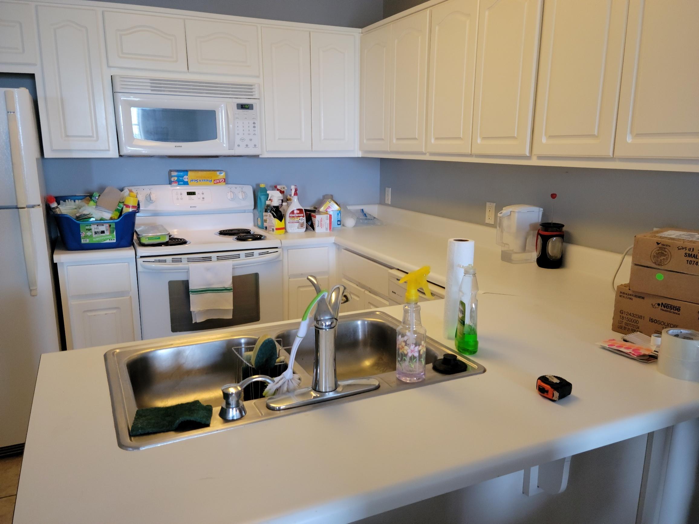 8436 Gulf Boulevard, Unit 423 Navarre, FL 32566 - Photo 5 of 7 a kitchen with a refrigerator and a stove top oven