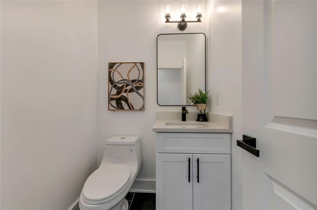 208 Watson Circle Southeast Atlanta, GA 30317 - Photo 22 of 45 a bathroom with a toilet sink and mirror