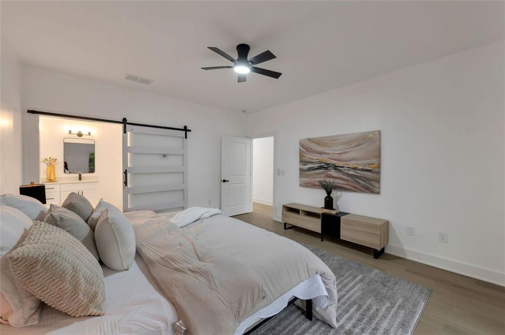 208 Watson Circle Southeast Atlanta, GA 30317 - Photo 25 of 45 a bedroom with a bed and a chandelier