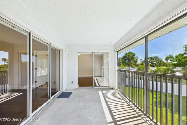 a view of washer and dryer with bathroom in the background